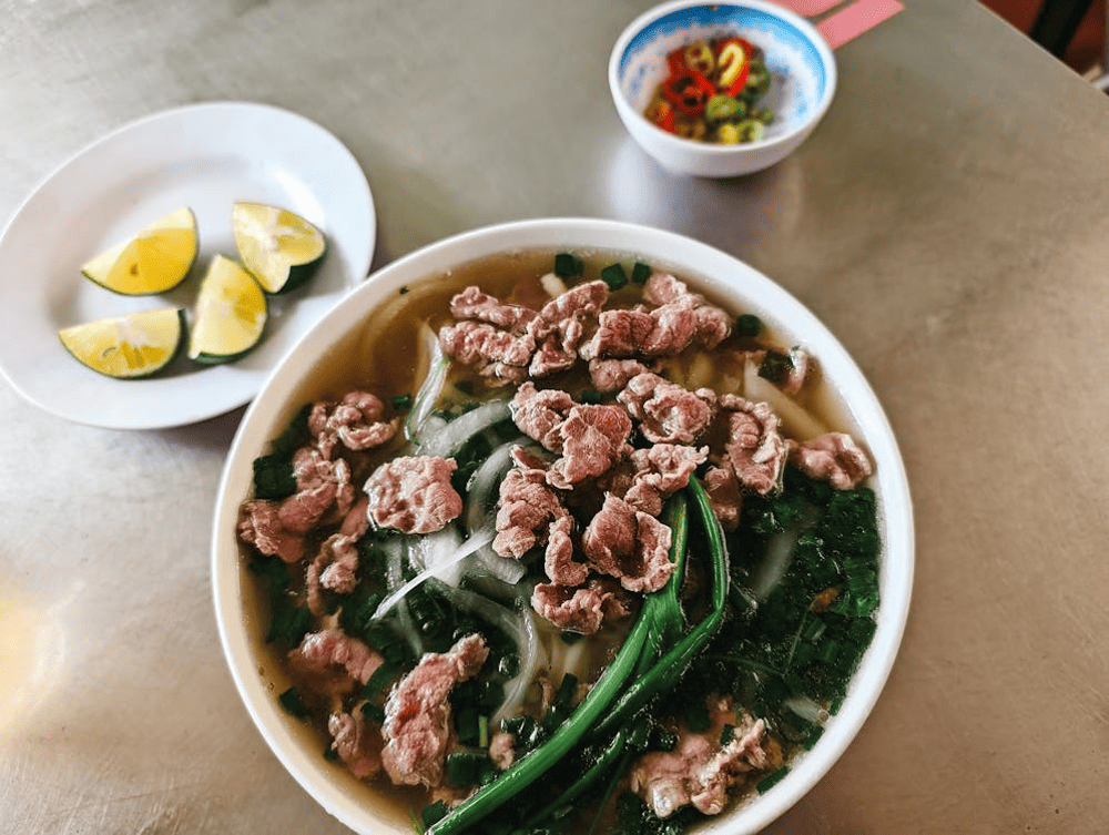 Pho is a traditional dish, featuring steaming hot broth, fresh beef, and crispy fried dough sticks served alongside (Source: Pexels)